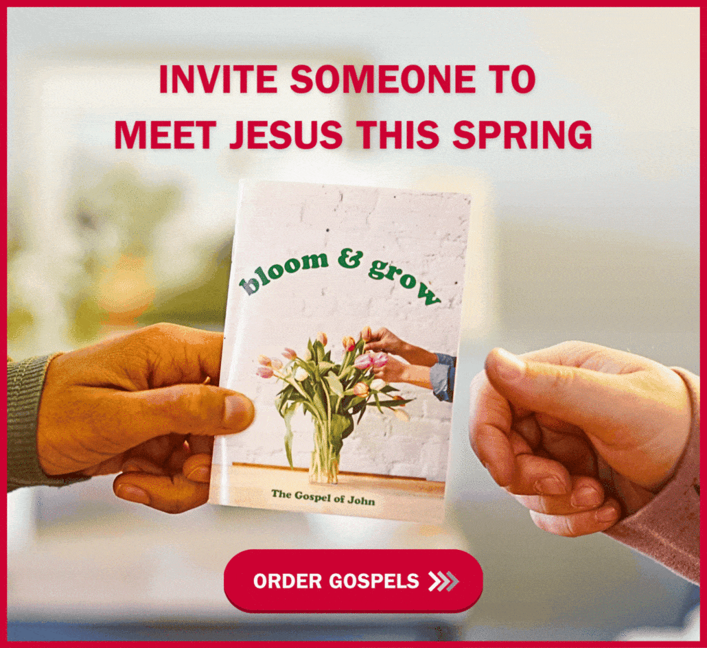 Two hands exchanging a booklet titled "bloom & grow, The Gospel of John" with flowers on the cover. Text above reads, "Invite someone to meet Jesus this spring." A red button below says, "Order Gospels.
