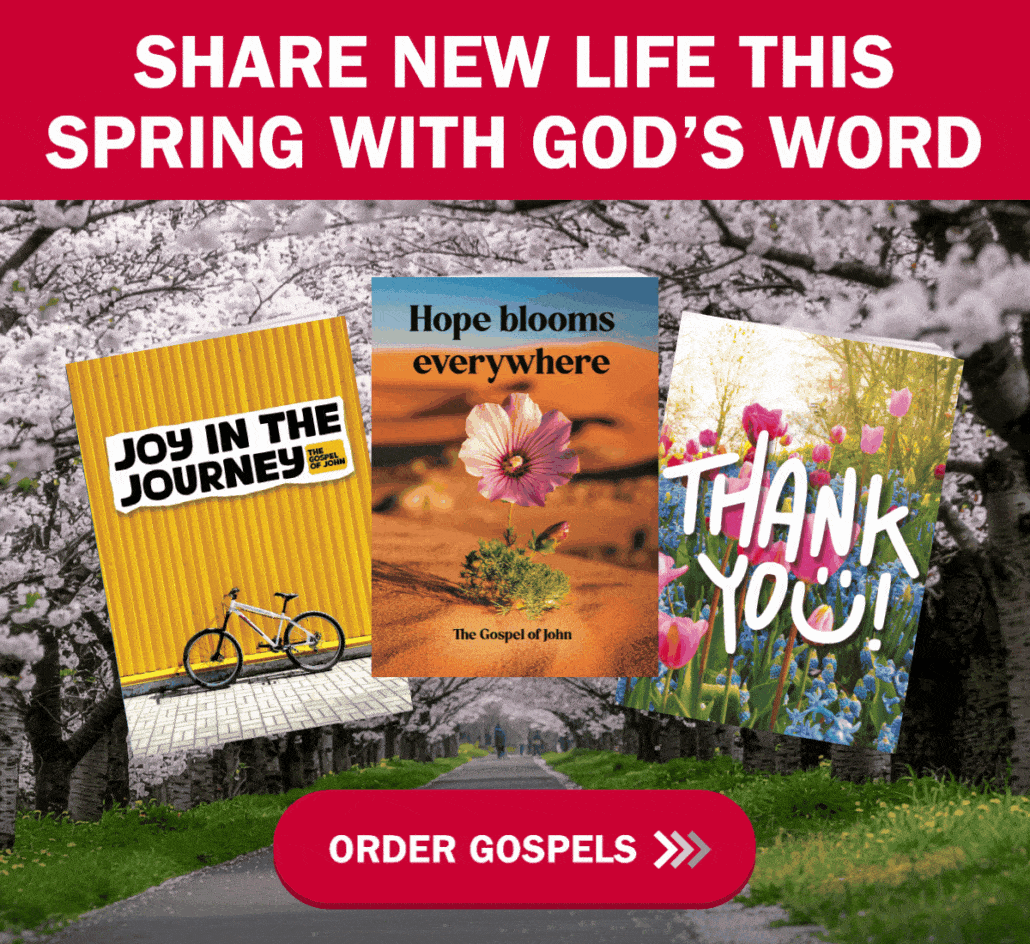 Three colorful booklets with inspirational covers are displayed above a tree-lined path. Text reads, "Share New Life This Spring With God's Word." A red button below says, "Order Gospels.